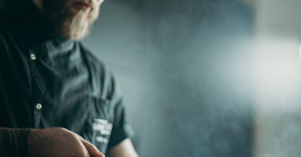 A focused chef prepares a meal using a frying pan in an indoor kitchen setting.
