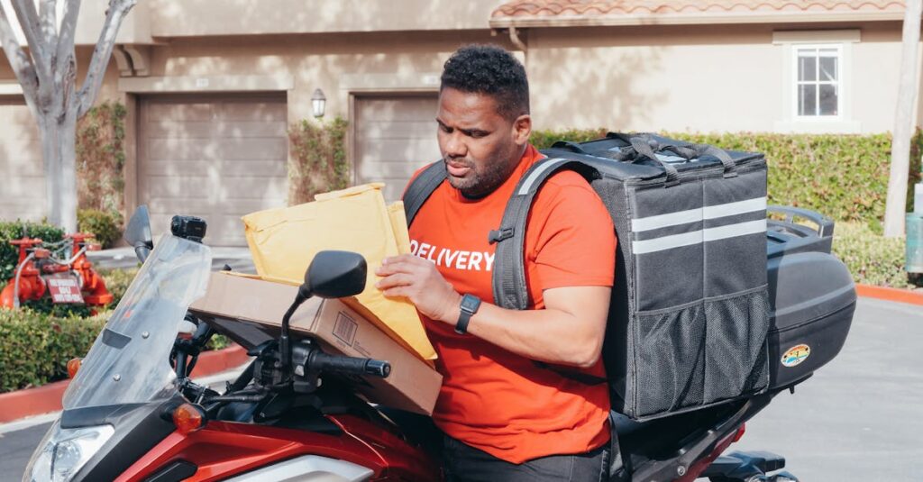 Man delivering parcels on a motorbike, illustrating the efficiency of package delivery services.