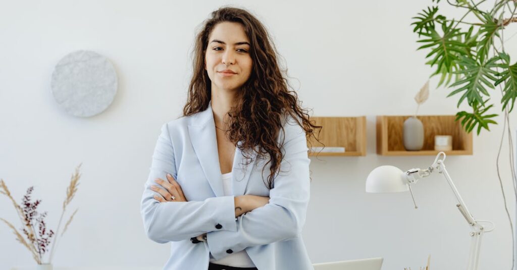 Professional woman with curly hair exuding leadership in a contemporary office environment.