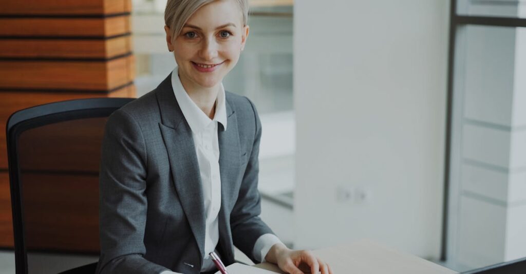 Professional businesswoman smiling at desk in modern office environment.