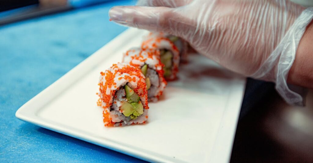 Chef prepares sushi rolls wearing gloves, emphasizing hygiene and precision.