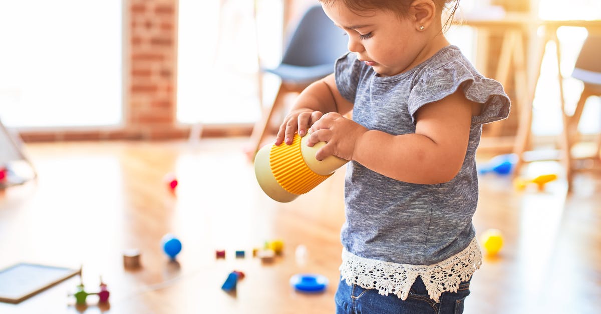 Cute toddler playing with toys in a bright nursery setting, enjoying playtime.